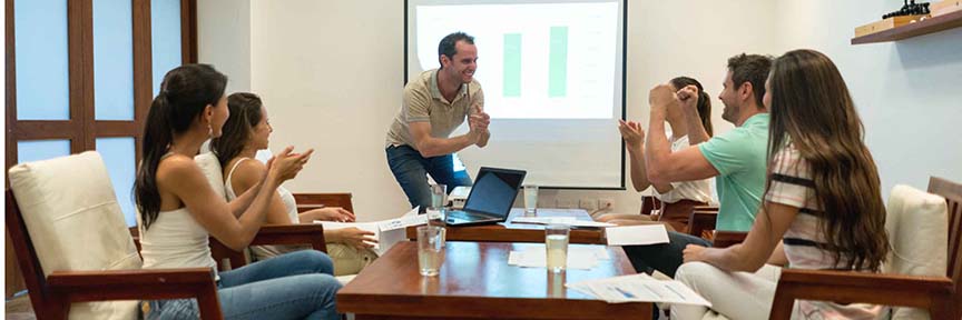 Business Presentations in English: In this image, the man giving the presentation and the people listening are very happy.