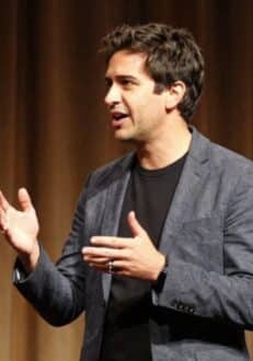 Business man on stage telling a story at a conference