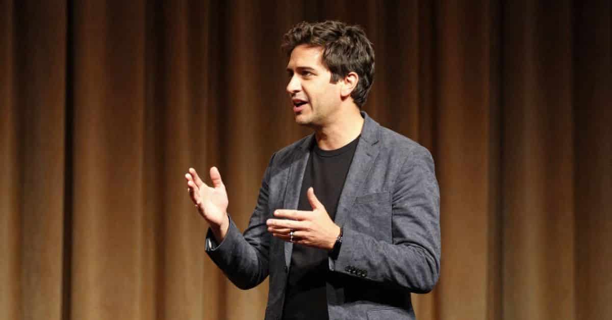 Business man on stage telling a story at a conference